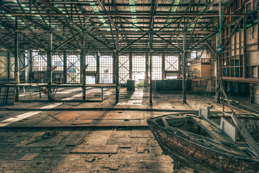 Deck at Halvorsens Boat Yard, steel columns rise from a worn timber deck inside a vast industrial shed.