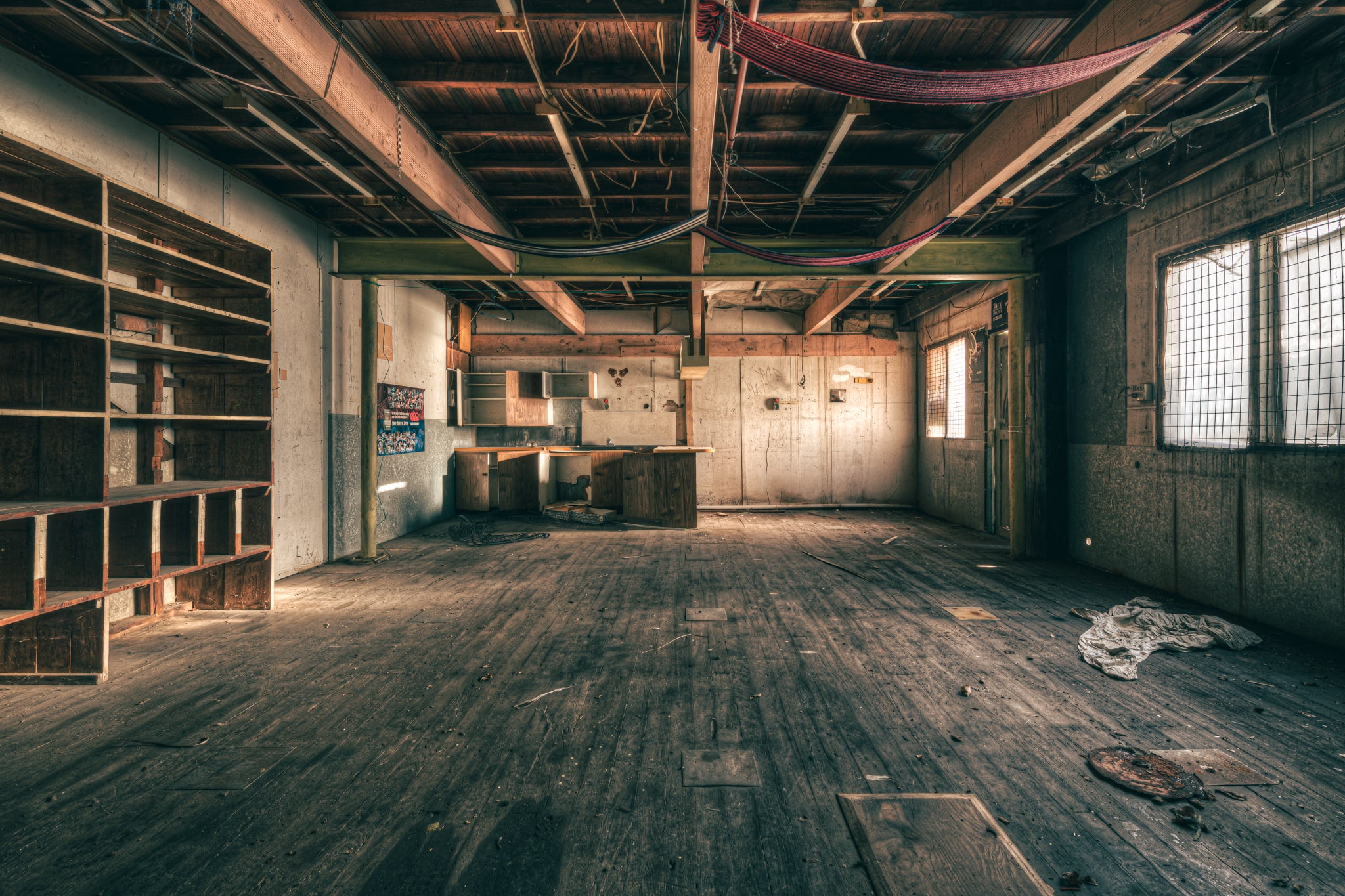 Storeroom at Halvorsens Boat Yard, a wide timber floor stretches across the storeroom, every plank grey with dust and grit.