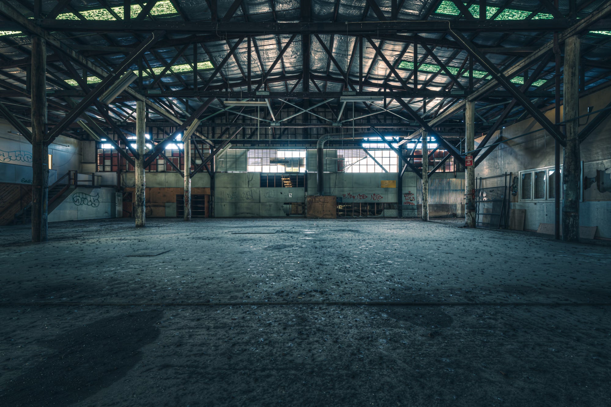 Warehouse at Halvorsens Boat Yard, steel trusses span the full width of the warehouse, supported by heavy timber columns.