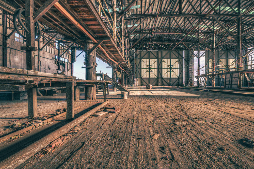 Workshop Floor at Halvorsens Boat Yard, worn timber planks stretch the full length of the workshop floor, their grain split.