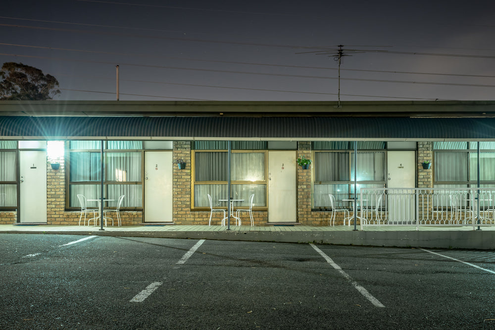 Abcott Inn at Hotel Motel 101, four rooms face an empty car park.