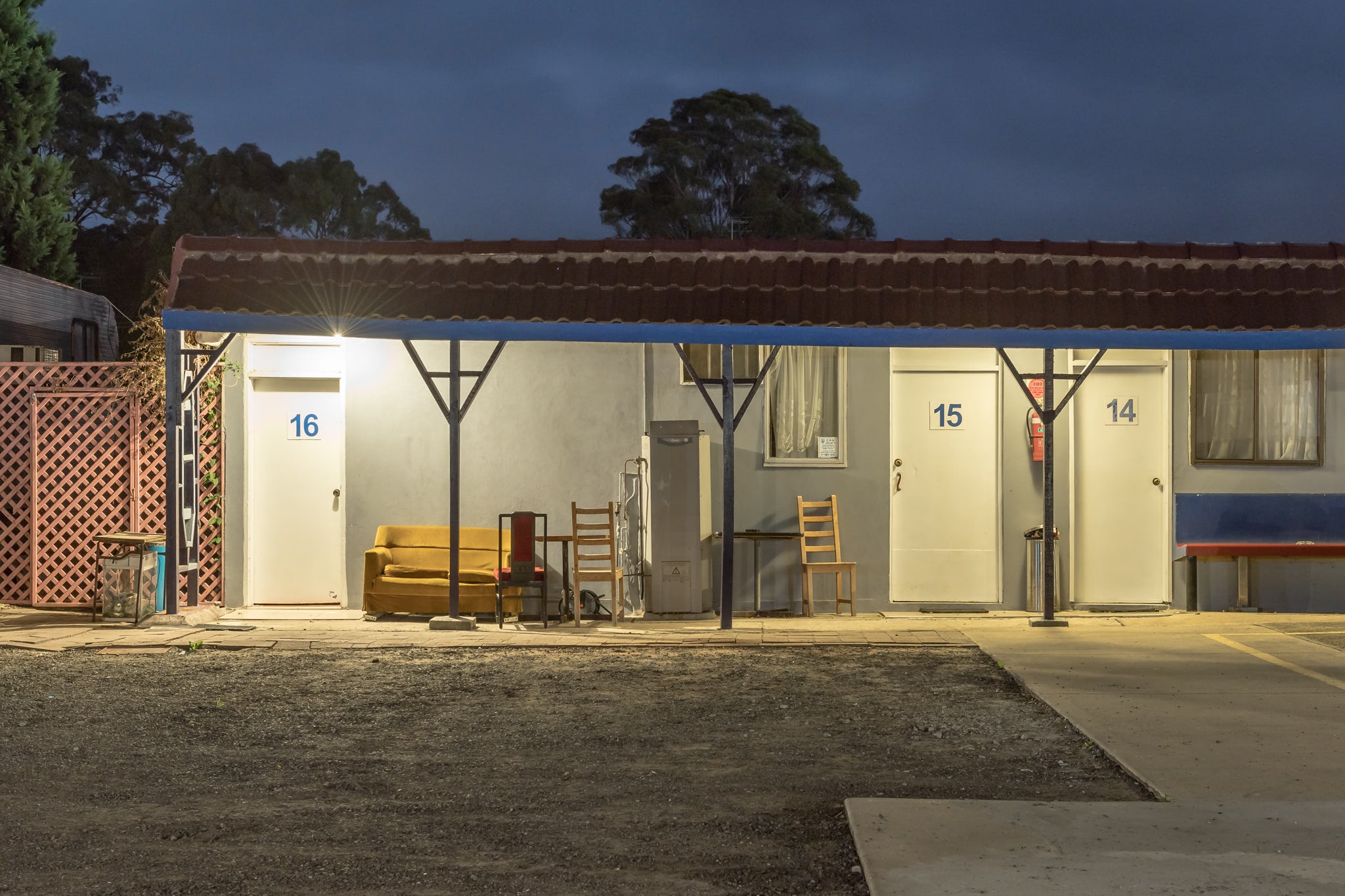 Appin Motel at Hotel Motel 101, a single security light burns above room 16, throwing hard white light across the concrete.