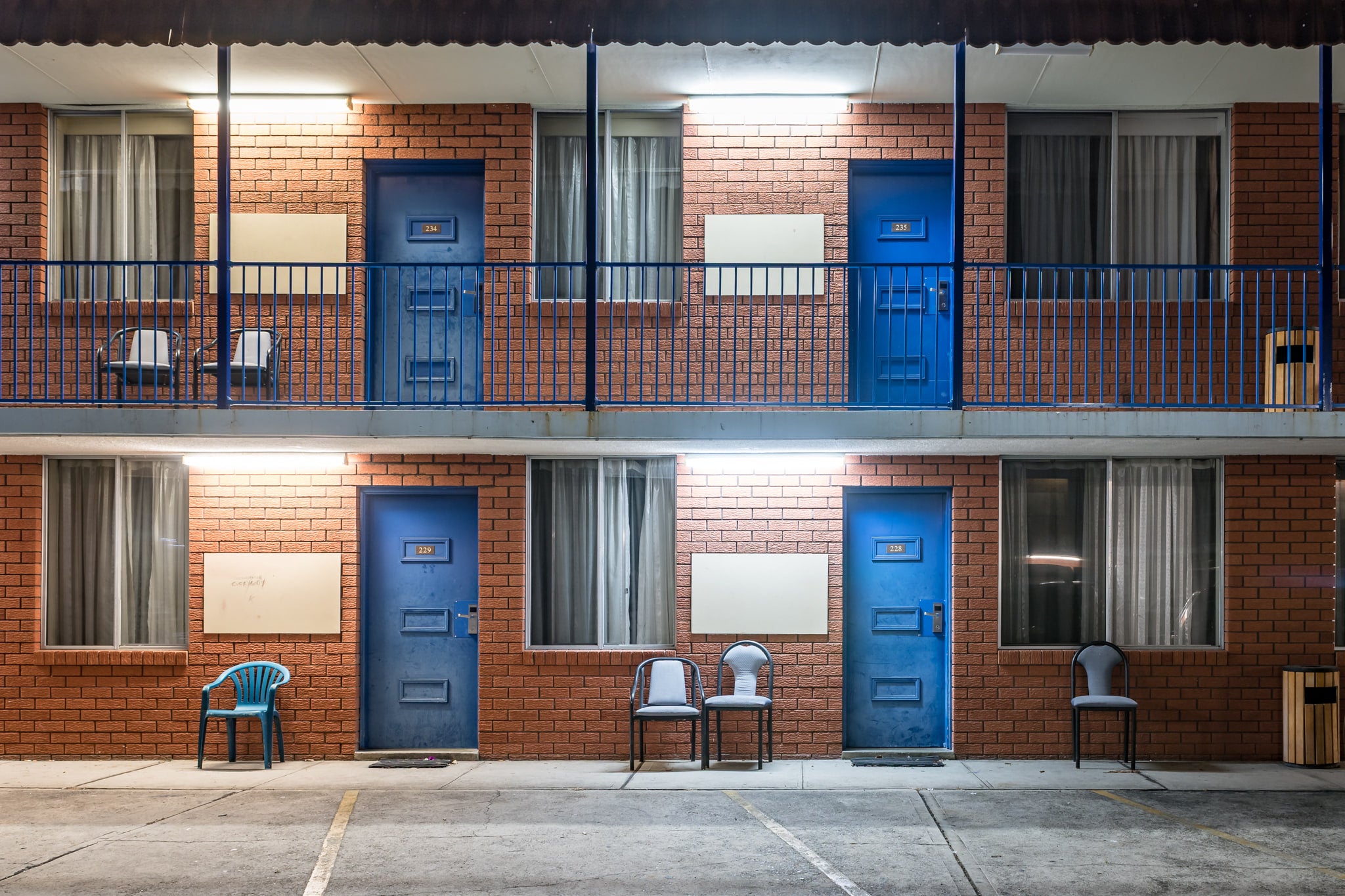 Ashfield Motor Inn at Hotel Motel 101, two storeys of brown brick and blue steel.
