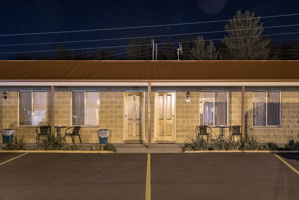 Black Gold Motel at Hotel Motel 101, two besser block rooms face an empty car park.