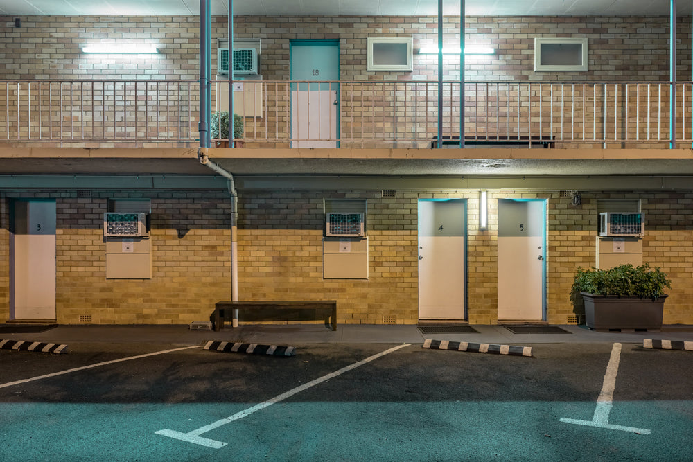 Blue Mountains Gday Motel at Hotel Motel 101, two storeys of cream brick face an empty car park.