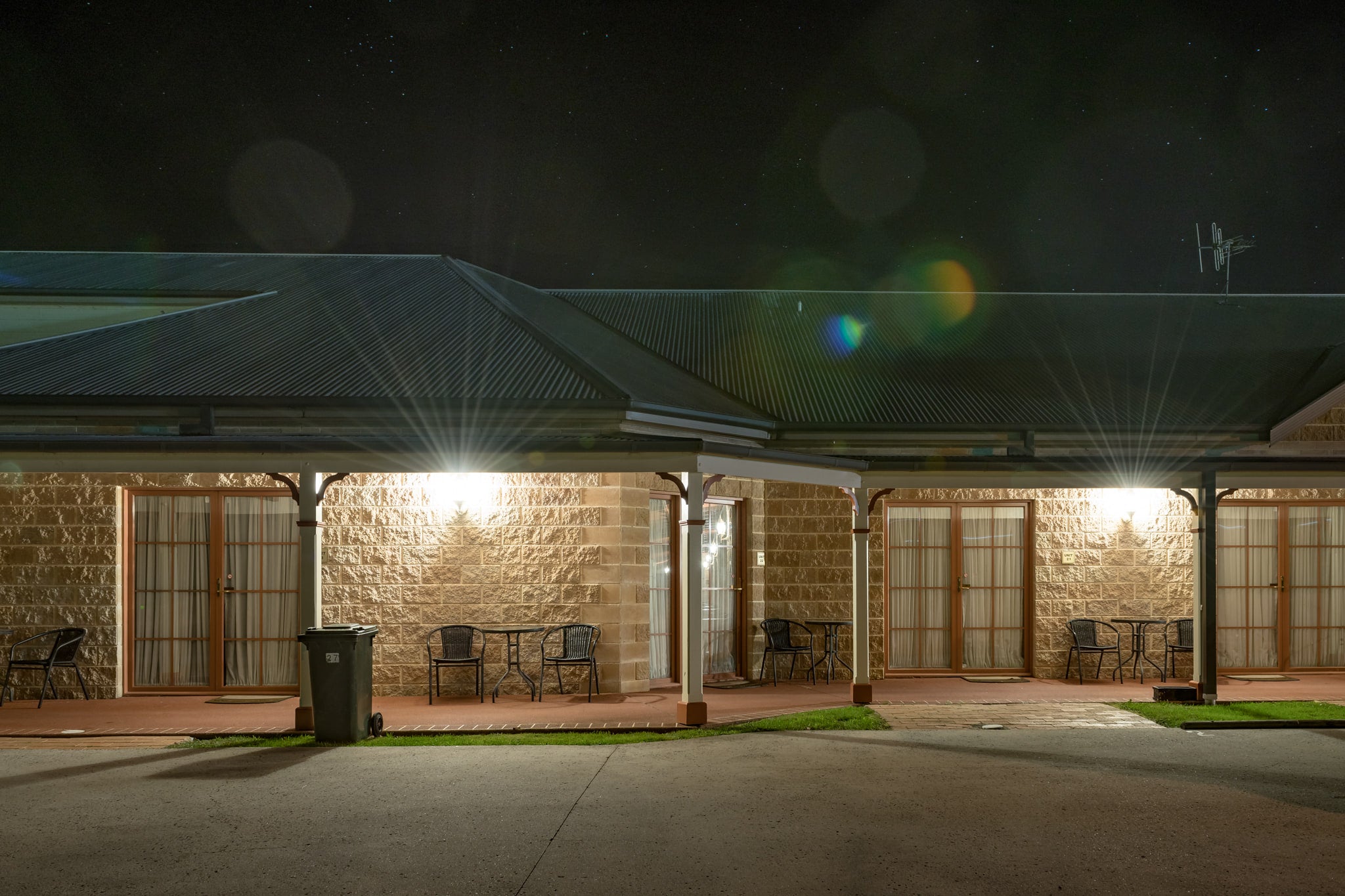 Bowen Inn Motel at Hotel Motel 101, split-face sandstone block walls run the length of the building, broken.
