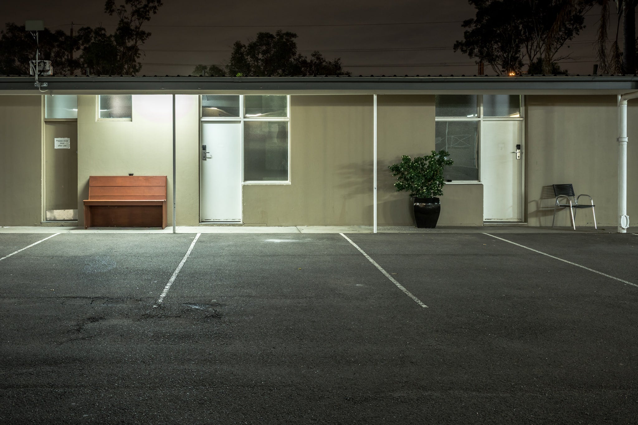 Colyton Hotel at Hotel Motel 101, a single-storey motel block sits flat against the night.