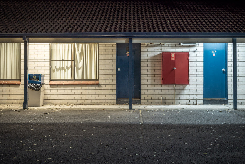 El Toro Motel at Hotel Motel 101, cream brick and blue doors under a flat tile carport.