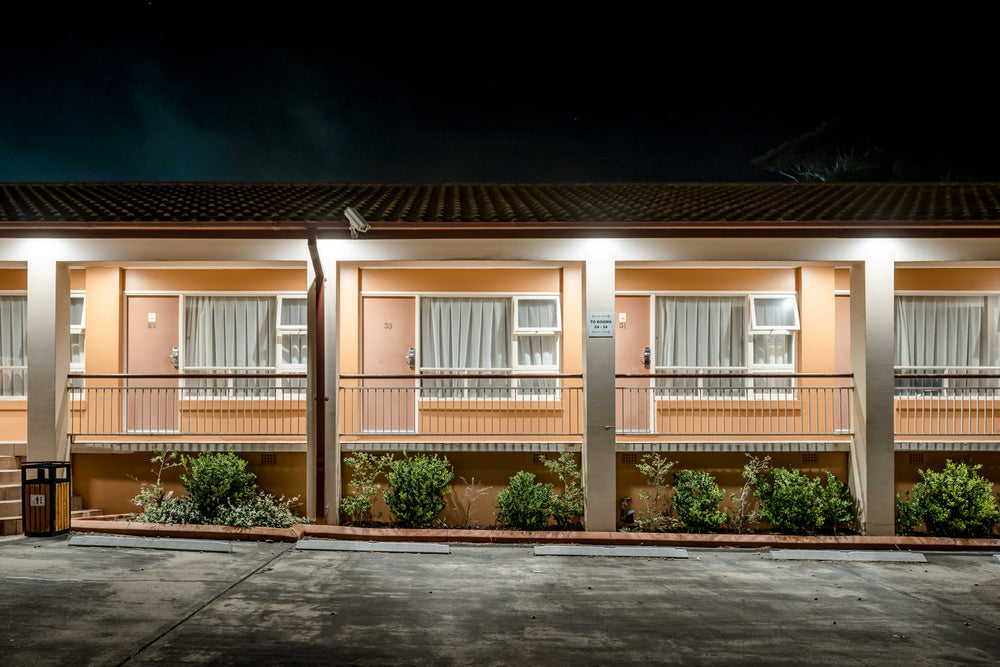 Engadine Motor Inn at Hotel Motel 101, peach-coloured render and concrete pillars divide the facade into identical bays.