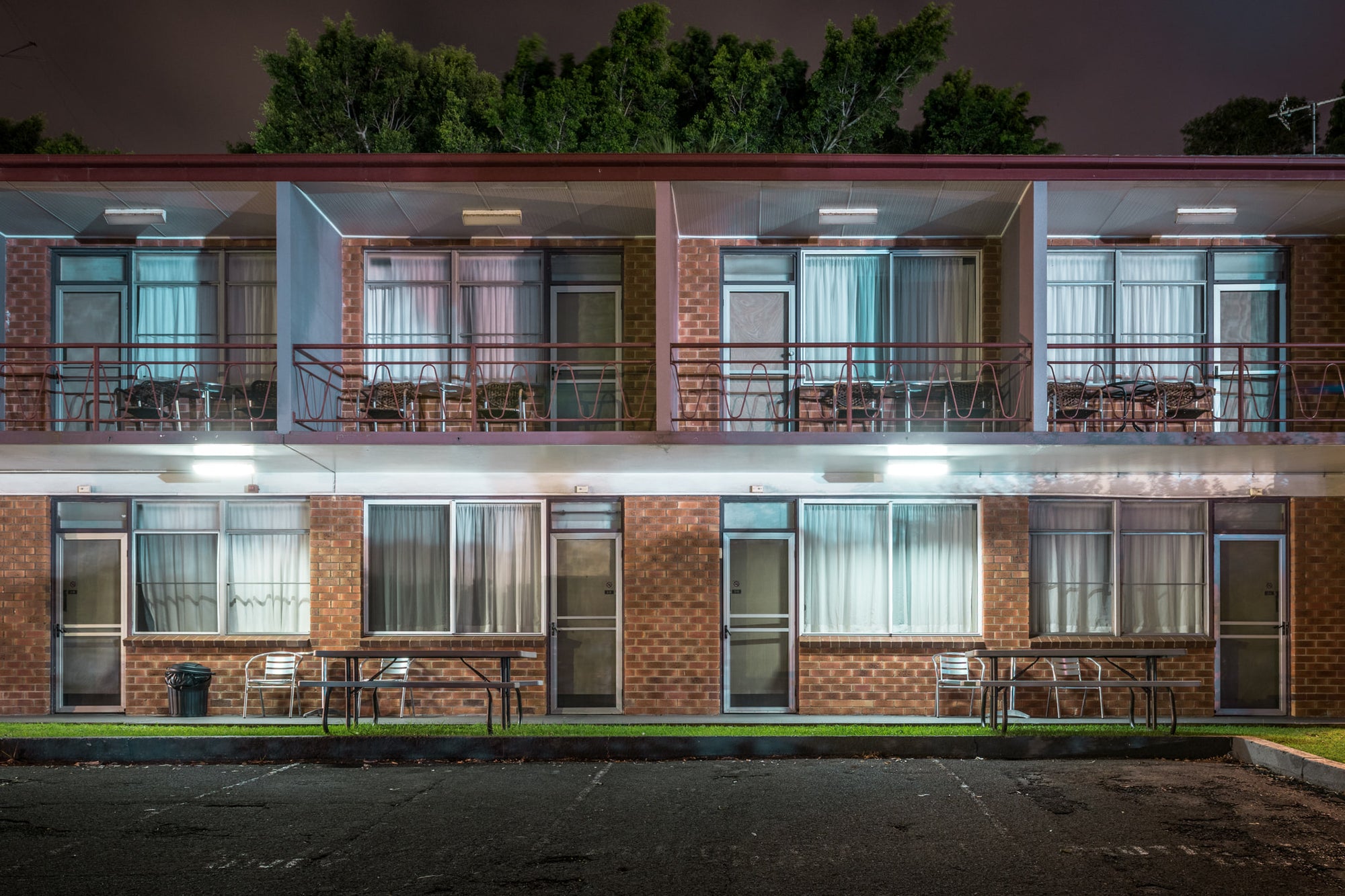 Flinders Motel, Wollongong at Hotel Motel 101, two levels of a low rise motel with car parking spaces in front and trees.