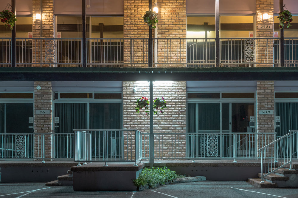 Gosford Inn Motel at Hotel Motel 101, two storeys of pale brick face an empty car park.
