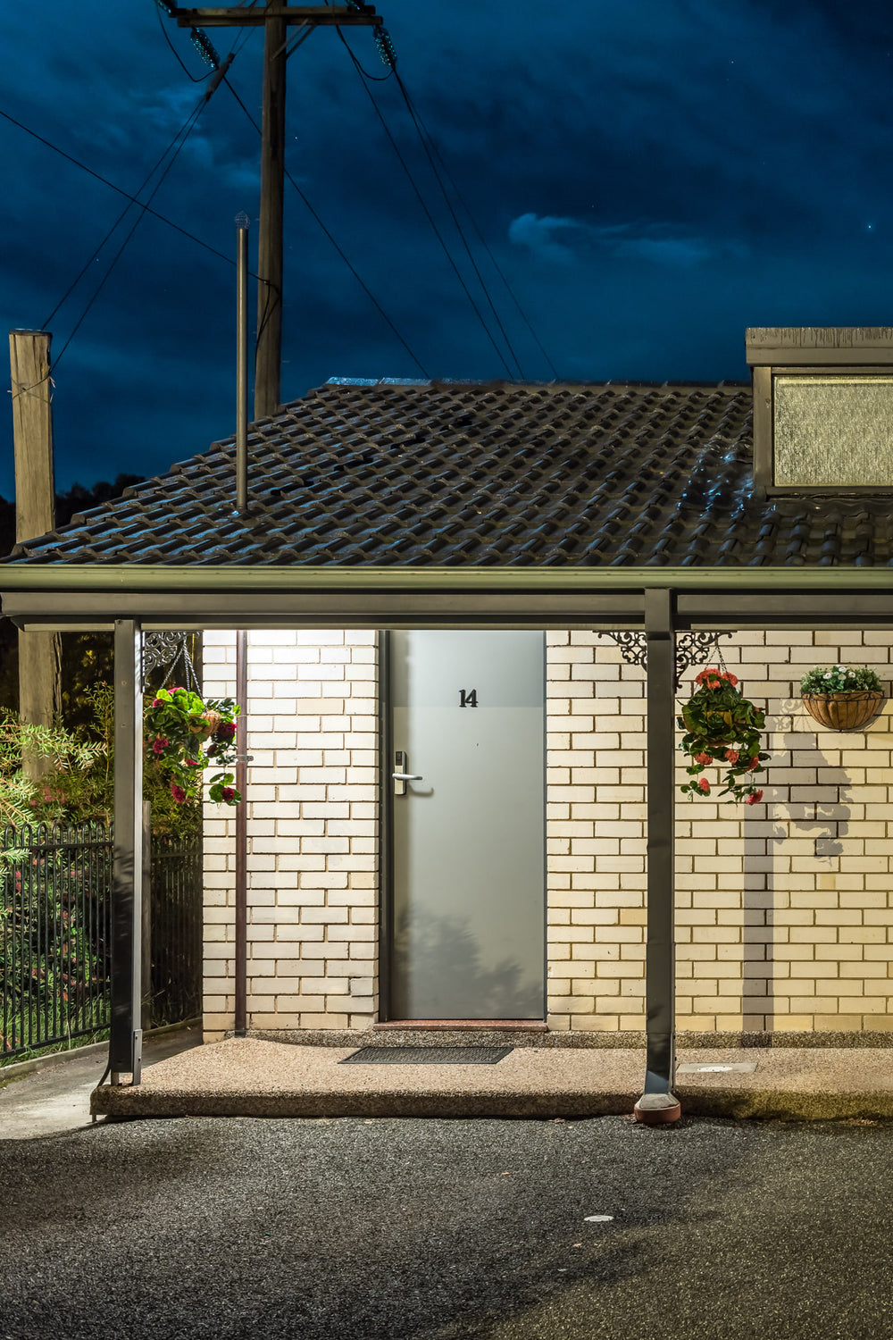Hibiscus Lakeside Motel at Hotel Motel 101, a steel door marked 14 sits flush against cream brick.