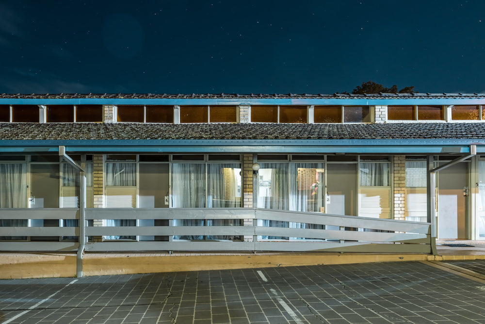 Jetty Motel at Hotel Motel 101, a single-storey motel block stretches across the frame under a deep night sky.