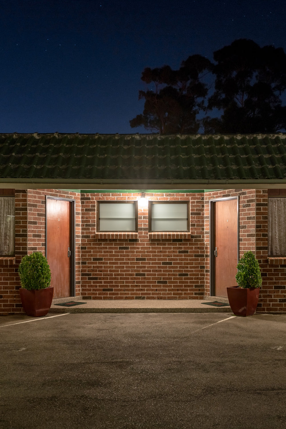Mt Kuring Gai Motel Mt Kuring Gai at Hotel Motel 101, two brown doors flank a single security light.