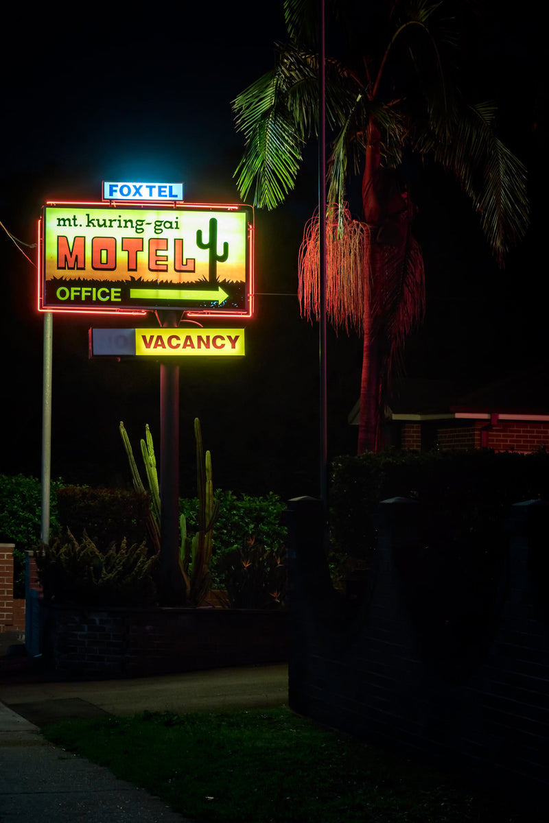 Mt Kuring-Gai Motel Sign at Hotel Motel 101, the neon sign for Mt Kuring-gai Motel burns against a black sky.