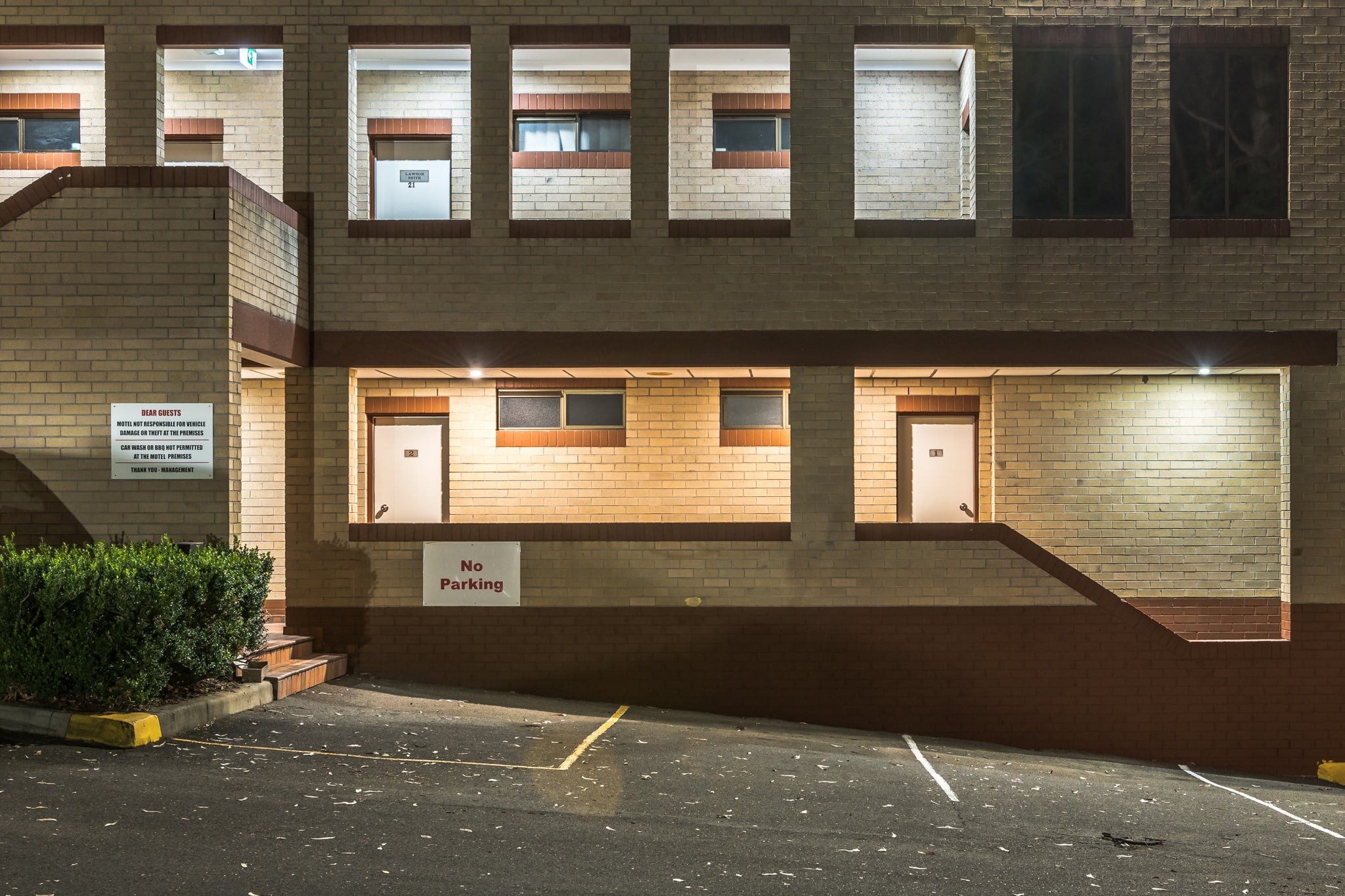 Penrith Valley Inn at Hotel Motel 101, two storeys of cream and brown brick rise above an empty car park.