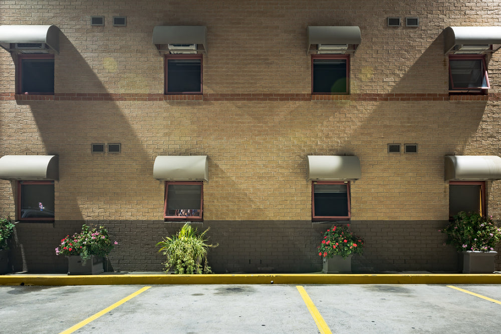 Sleep Express at Hotel Motel 101, two storeys of blonde brick face an empty car park.