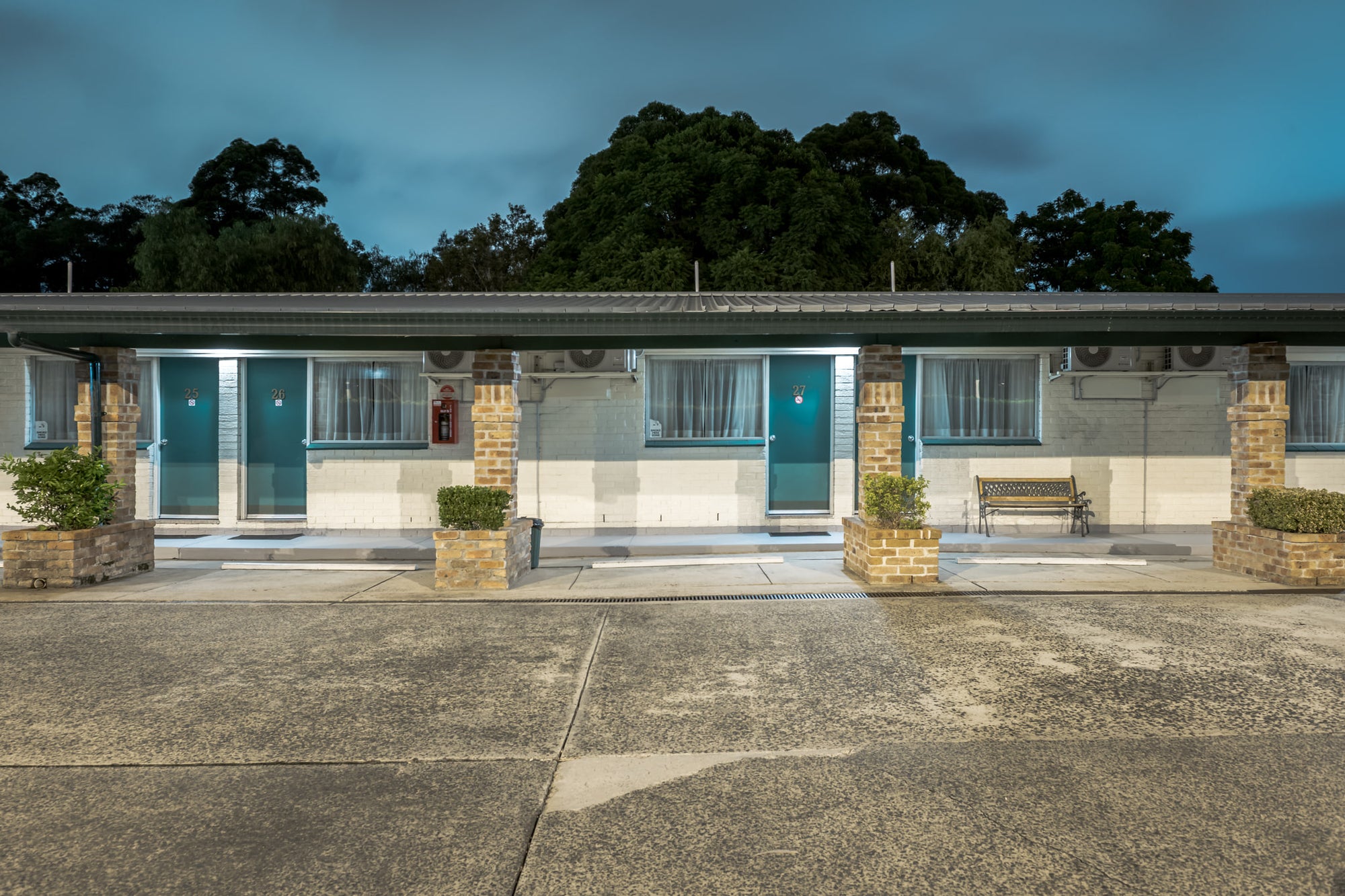 Sovereign Inn Wollongong Motel at Hotel Motel 101, teal doors numbered 25, 26, 27.