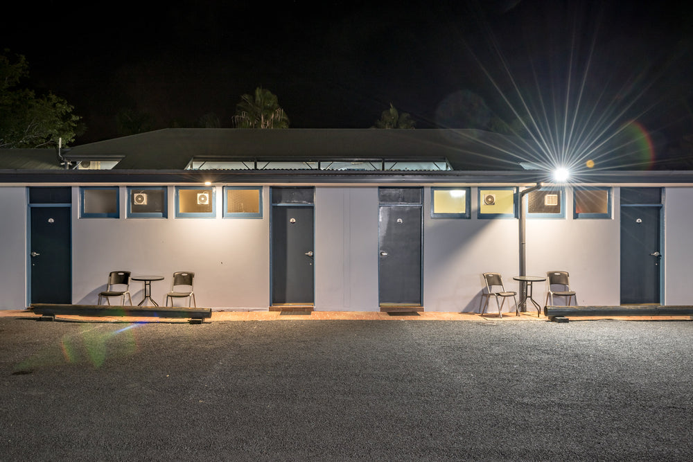The Colonial Motel at Hotel Motel 101, a single-storey motel block sits flat against the night.