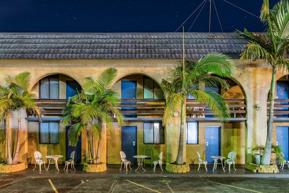 The Entrance Reef Resort, The Entrance at Hotel Motel 101, a Kitsch motel with palm trees in front of yellow arches.