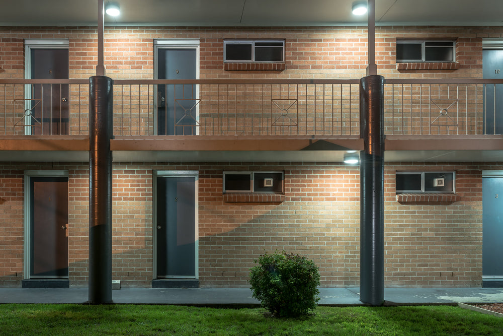 The Oaks Motel at Hotel Motel 101, two storeys of brown brick face the car park under fluorescent security lights.