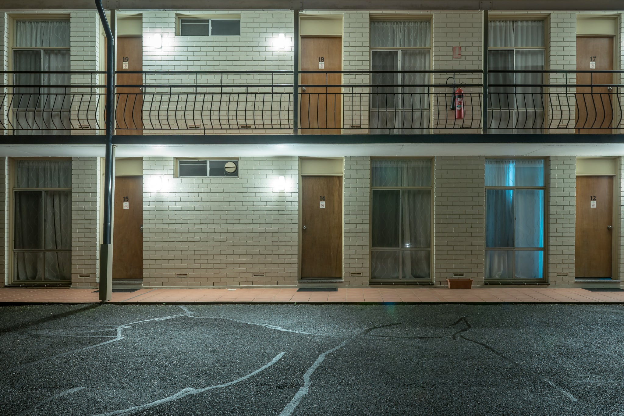 Waterview Gosford Motor Inn at Hotel Motel 101, two storeys of cream brick face an empty car park.