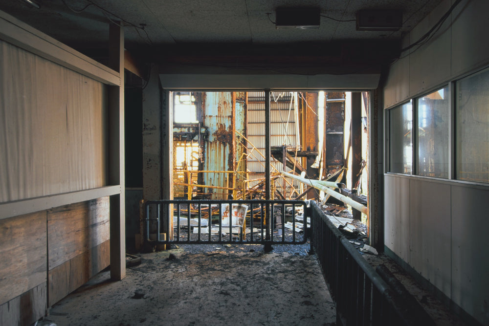 Doorway in the No. 2 Shaft office at Ikeshima Coal Mine, a Keep Out barrier in front of the rusting headframe steel.