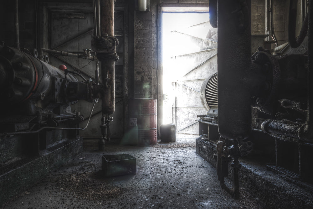 Compressors at Kandos Cement Works, two heavy compressors crowd a narrow passage deep inside the plant.
