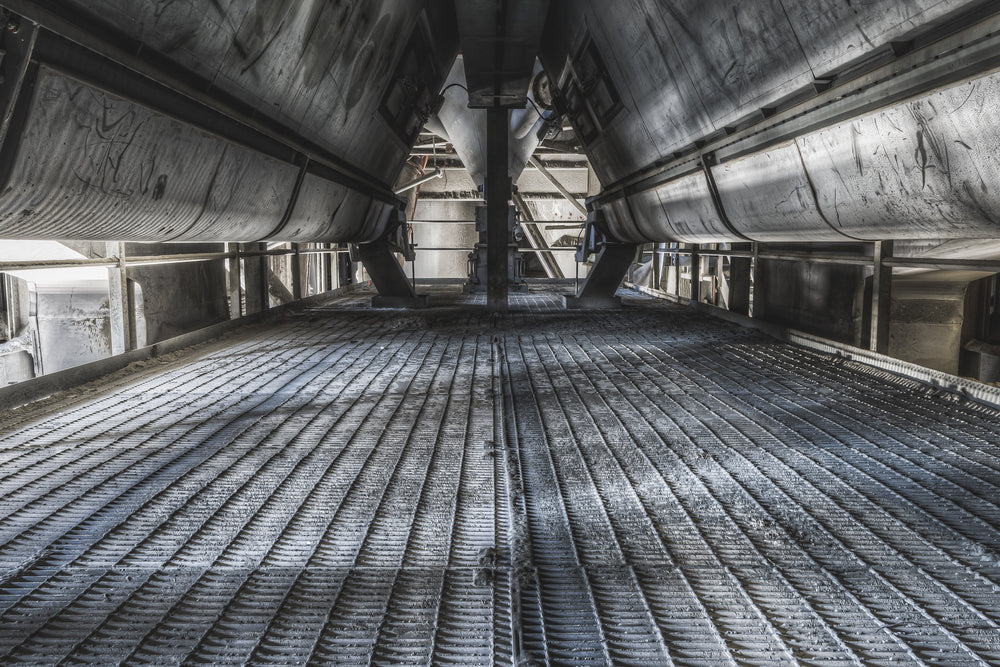 Dust Screws at Kandos Cement Works, two massive screw conveyors run parallel overhead, their steel housings converging.
