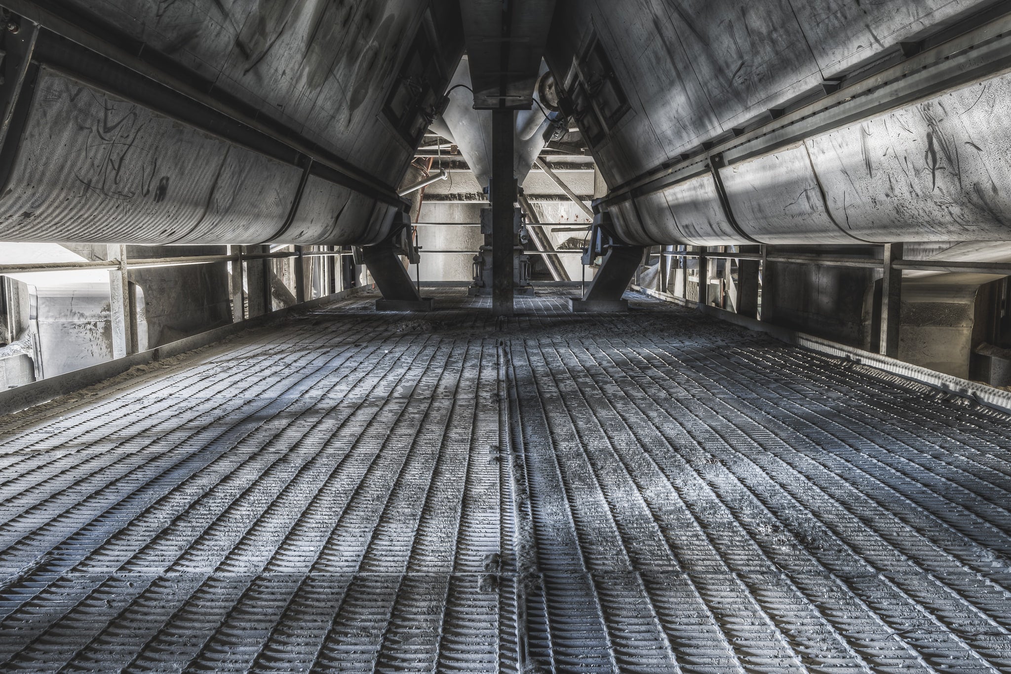 Dust Screws at Kandos Cement Works, two massive screw conveyors run parallel overhead, their steel housings converging.