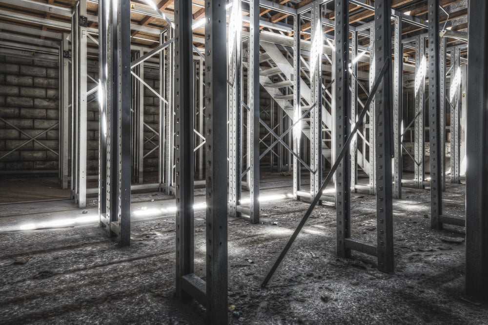 Old Store Shelving at Kandos Cement Works, steel pallet racking stands in tight rows across a concrete floor thick.