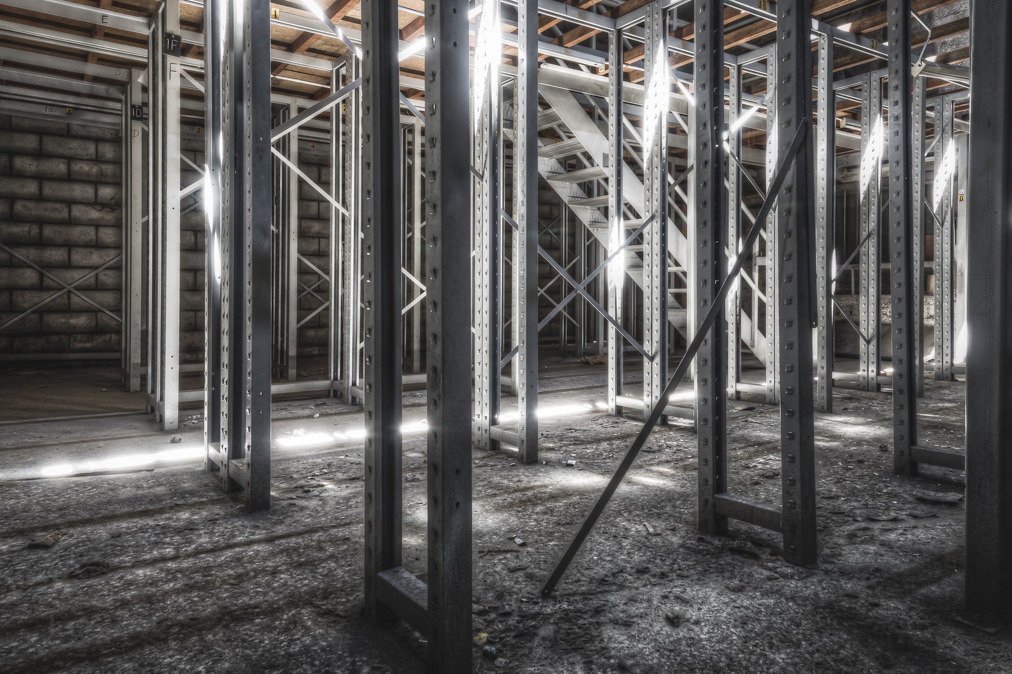 Old Store Shelving at Kandos Cement Works, steel pallet racking stands in tight rows across a concrete floor thick.