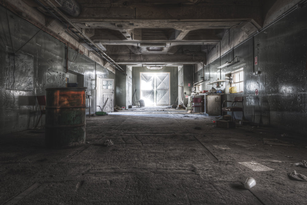 Plant Services Workshop at Kandos Cement Works, a rusted 44-gallon drum sits against the left wall.