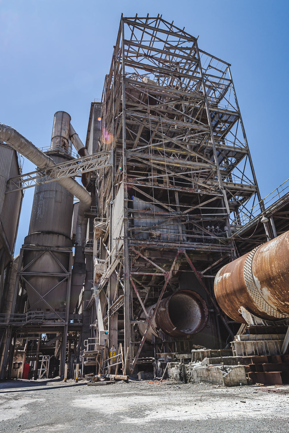 Preheater Building at Kandos Cement Works, a lattice of steel framing rises several storeys against open sky, its cladding.