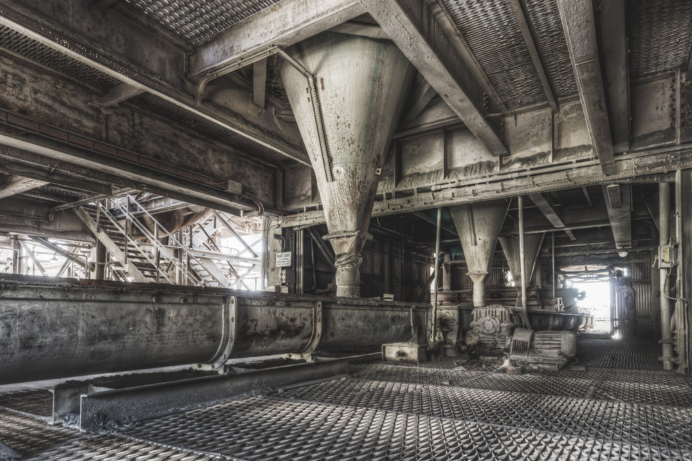 Screw Conveyor at Kandos Cement Works, steel hoppers taper to narrow discharge points above a screw conveyor trough.