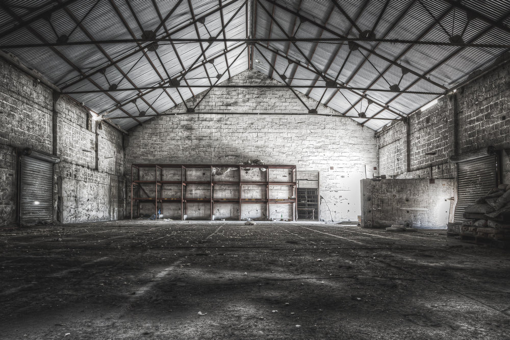 Store Building at Kandos Cement Works, steel trusses span the full width of the building, bolted to thick limestone block.