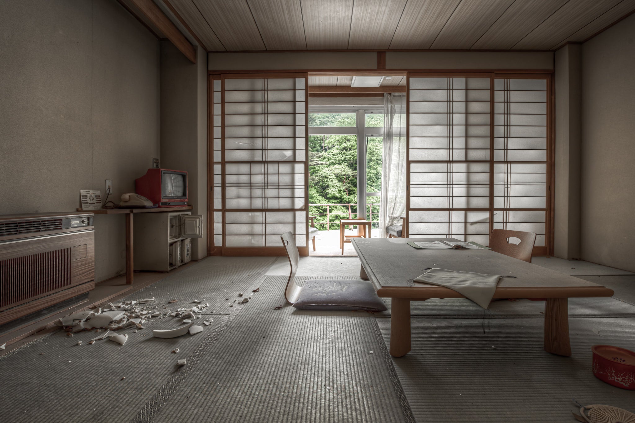 Guest Room at Kinugawa Kan, a low chabudai table sits at the centre of the room, zaisu chairs still positioned around it.