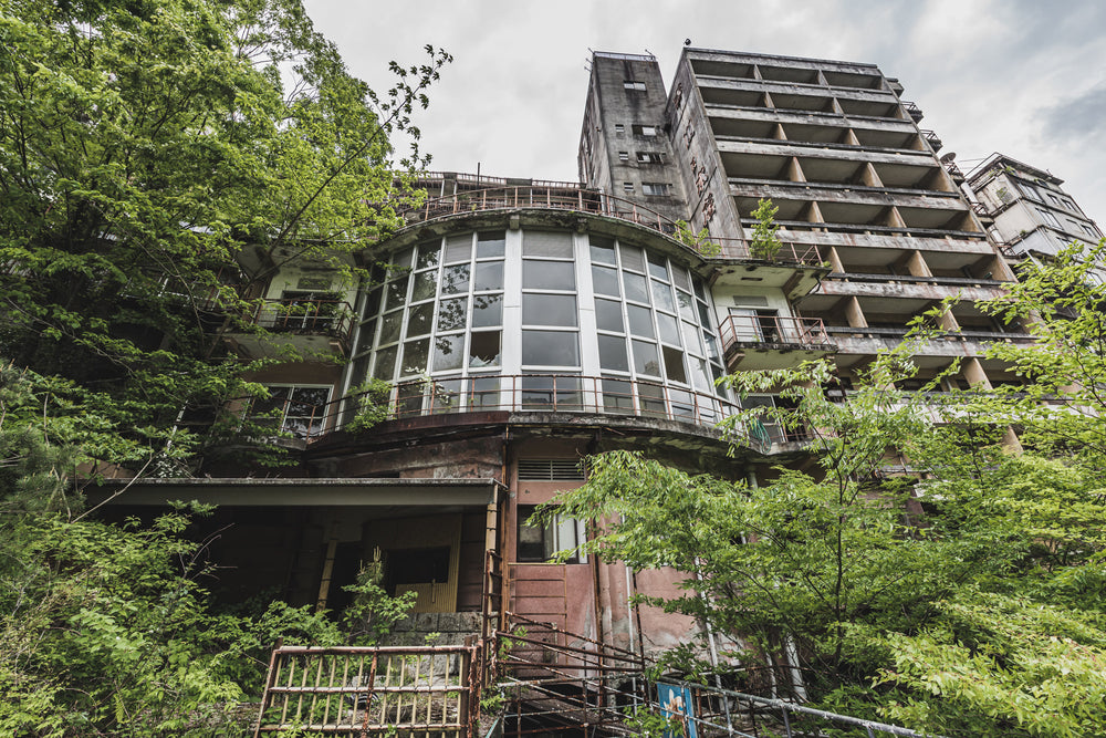 Kappa Onsen and Kinugawa Kan at Kinugawa Kan, a curved bay of windows juts from the lower facade of Kinugawa Kan.
