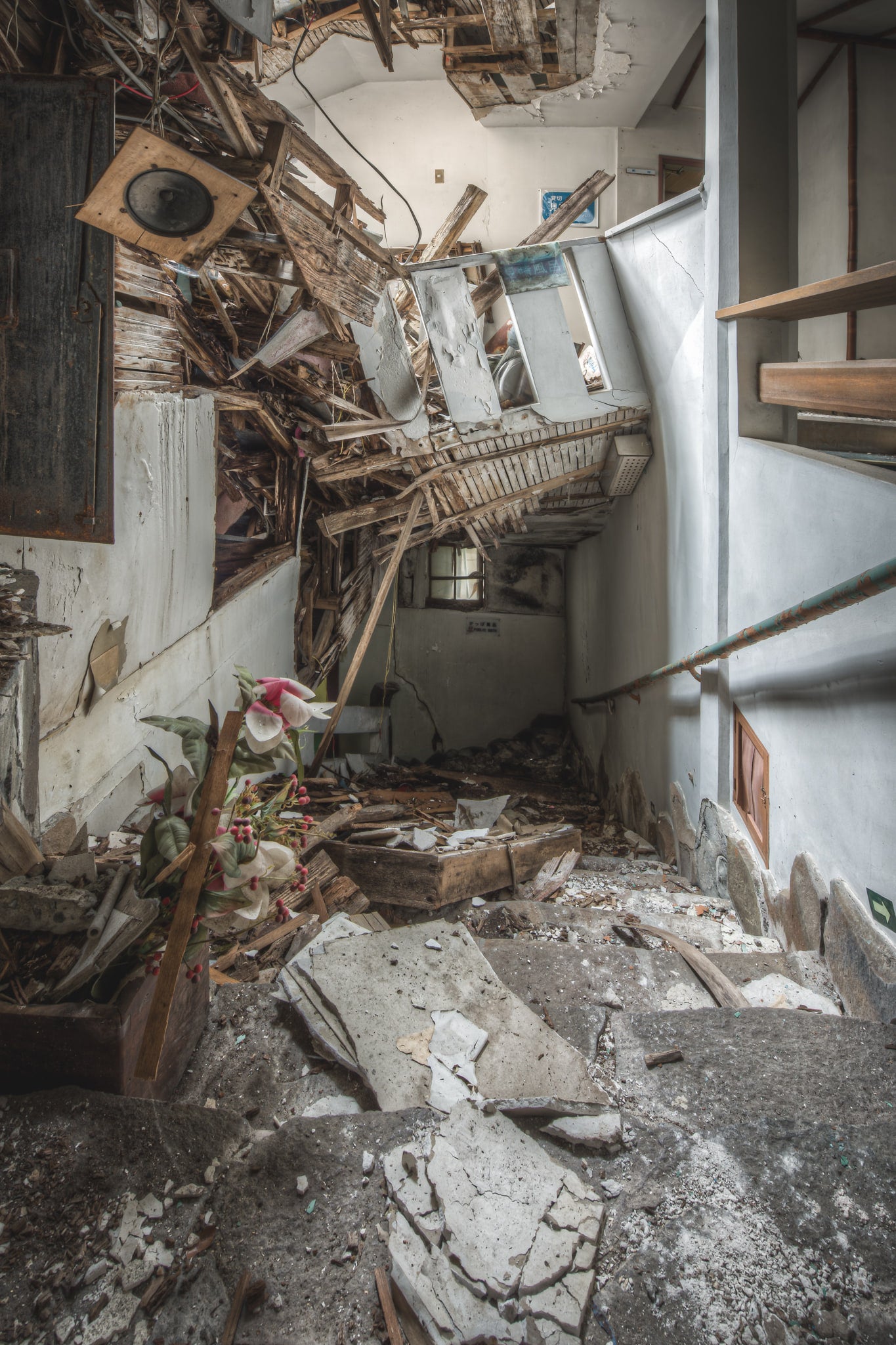 Public Bath Access at Kinugawa Kan, stone steps descend into a narrow corridor choked with debris.