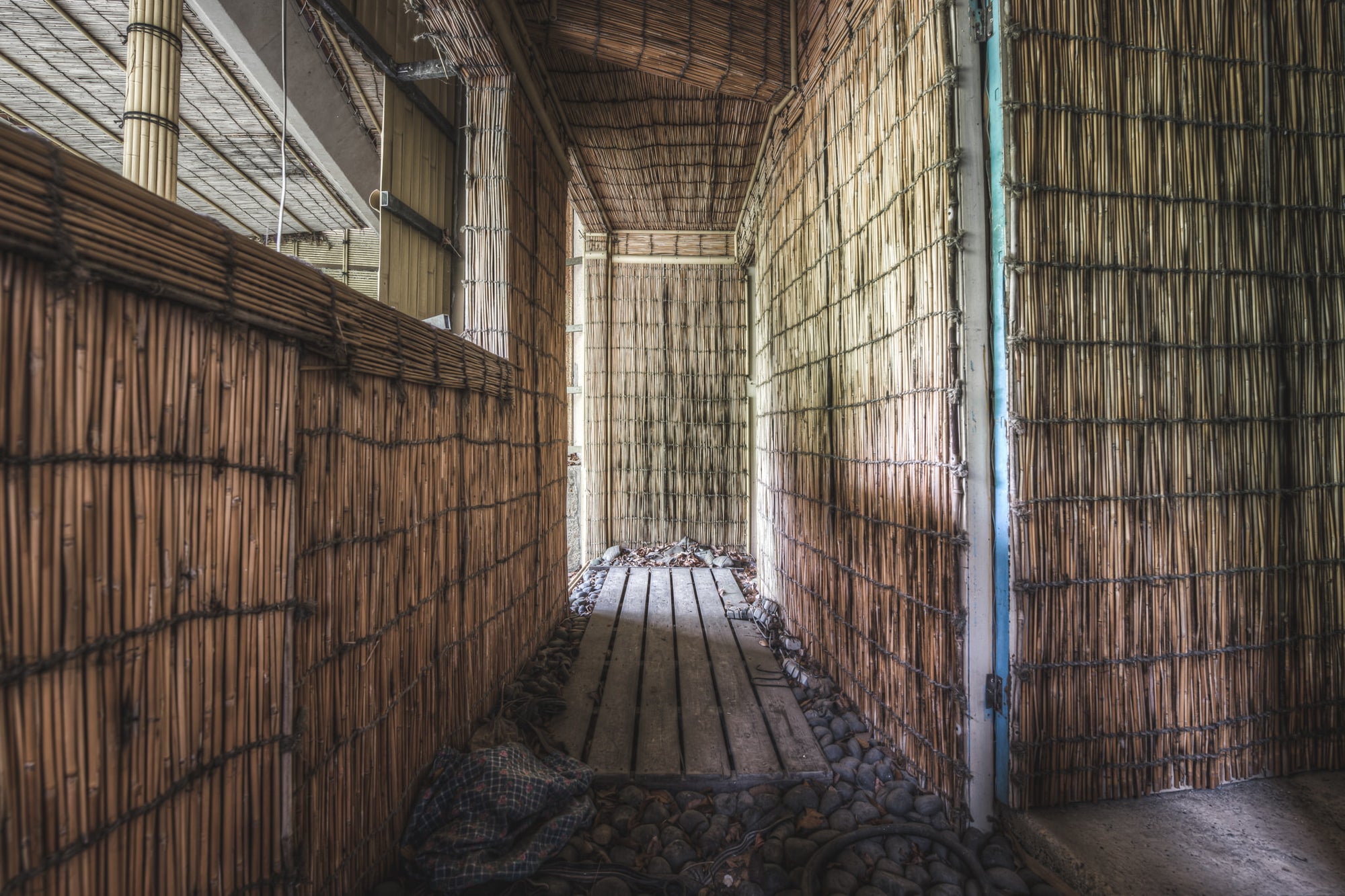 Thatched Walkway at Kinugawa Kan, bamboo reed panels line both walls of a narrow corridor inside Kinugawa Kan.