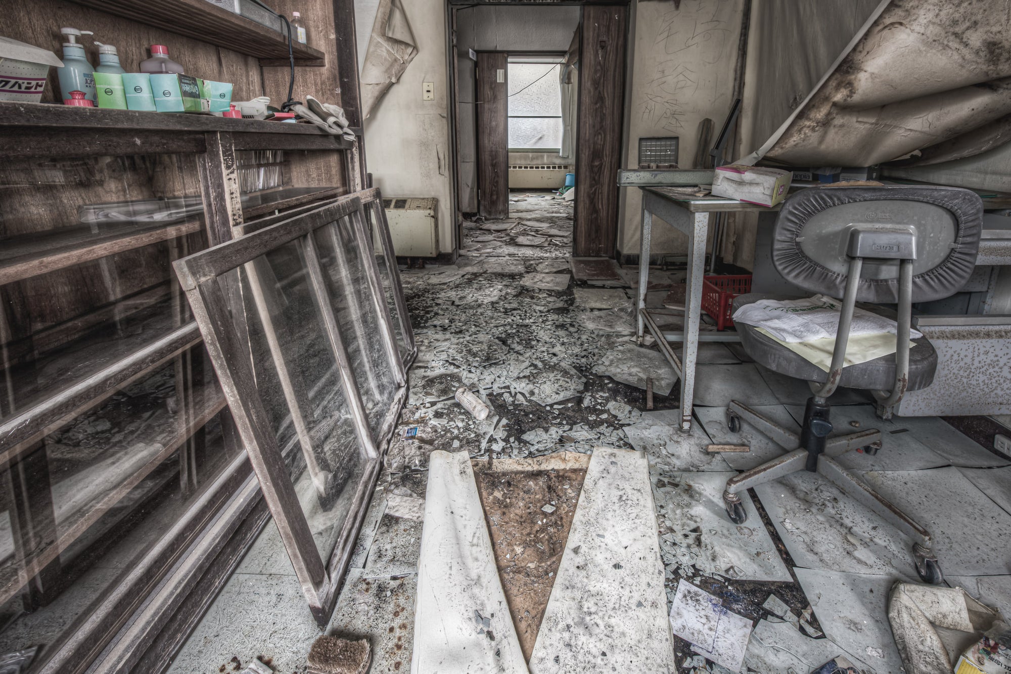 Chemical Storage at Kuwashima Hospital, a glass-fronted cabinet lines the left wall, its sliding panels removed and leaned.