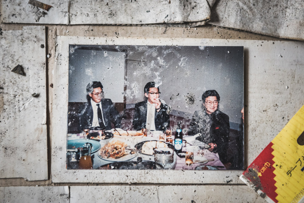Doctors Dinner at Kuwashima Hospital, a colour photograph lies on stained tile flooring.