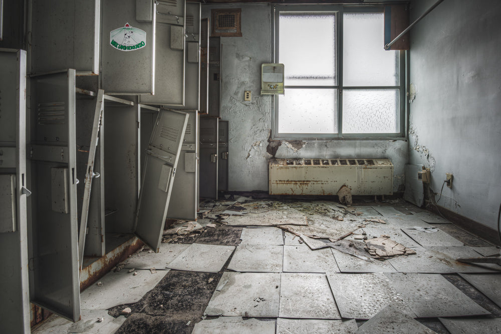 Locker Room at Kuwashima Hospital, steel lockers line the left wall, doors wrenched open or hanging at angles.