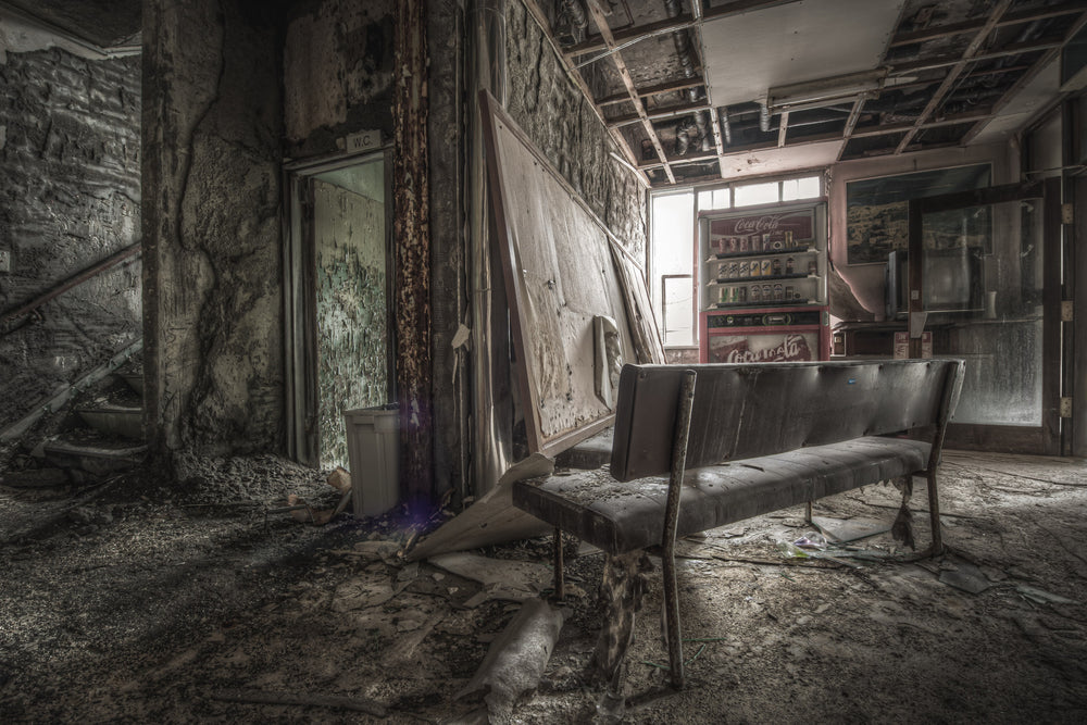 Waiting Room at Kuwashima Hospital, a vinyl bench sits in the centre of the ground-floor lobby, its chrome legs corroded.