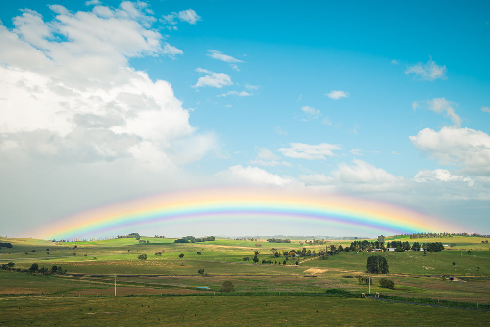 Blayney Rainbow at Landscapes, a rainbow stretching across farmland in the Central West New South Wales township of Blayney.