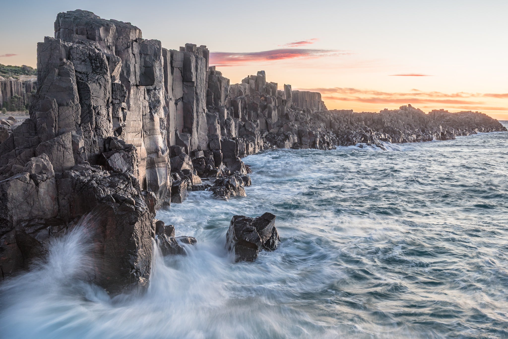 Bombo Quarry at Landscapes, waves crashing against the rocks at sunrise.