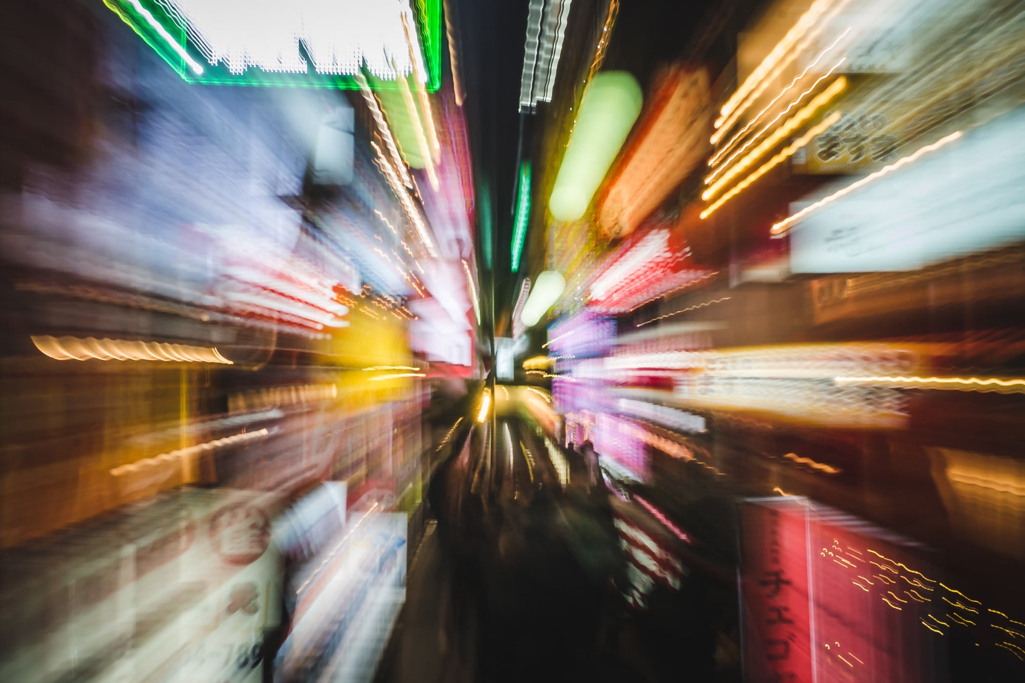 Light Zoom at Landscapes, neon signage streaks outward from a central vanishing point in a narrow Japanese alley.