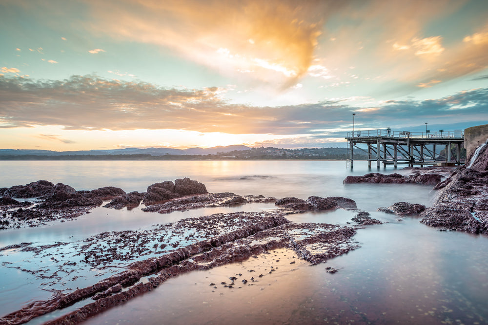 Merimbula Wharf at Landscapes, sun setting over Lake Merimbula.