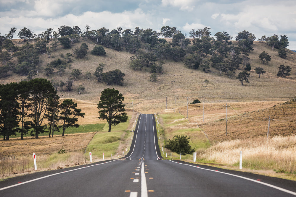 Monaro Highway at Landscapes, a road that rises and falls with the land, carving a path through the rolling hills of the Monaro.