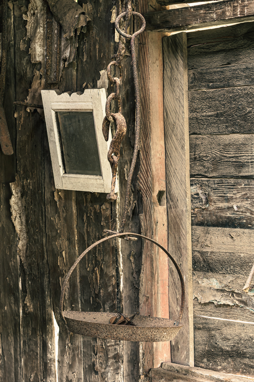 Hanging Scale at Leichhardt House, a rusted iron scale hangs from a heavy chain and ring bolt fixed to the exterior wall.